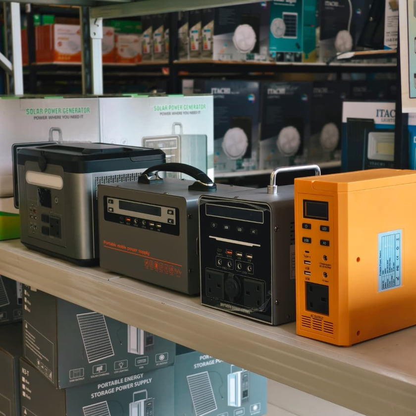 Four portable solar power stations of different sizes lined up on a shop shelf.